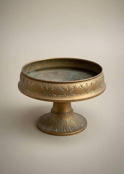 A decorative brass tazza bowl sitting on a pedestal by Daalderop of Holland.