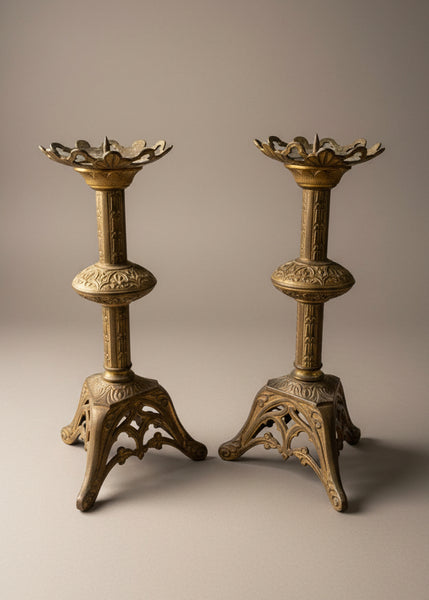 A pair of gilt brass/bronze church pricket candlesticks in a gothic revival style.