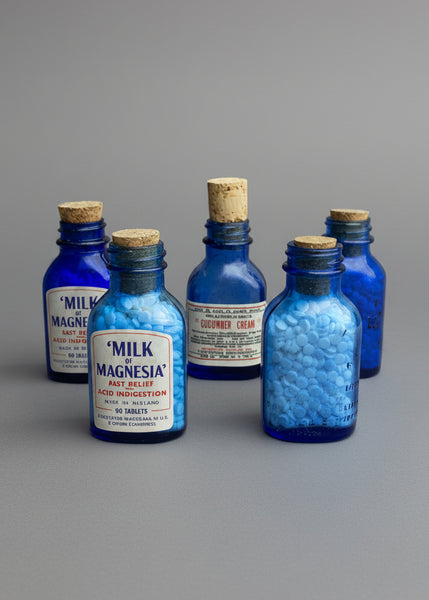 A collection of miniature cobalt blue vintage medicine bottles with cork stoppers. Circa 1930s.