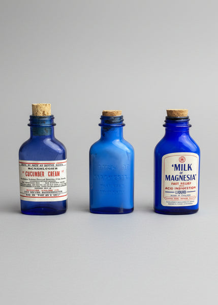A collection of miniature cobalt blue vintage medicine bottles with cork stoppers. Circa 1930s.
