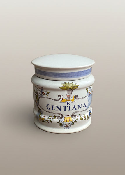 A set of vintage apothecary canister jars, with herbs as medicines in Latin botanical illustrations.