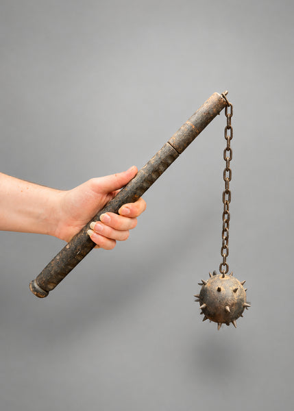 A medieval horseman spiked ball and chain flail weapon.