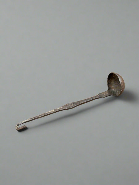 Large metal ladle with a hammered effect bowl.