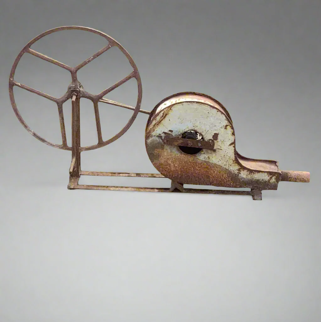 Antique blacksmith's forge blower. It would have had a belt to crank the wheel and cause the blower to work- a step up from a hand set of bellows.