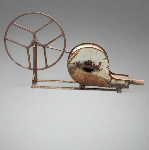 Antique blacksmith's forge blower. It would have had a belt to crank the wheel and cause the blower to work- a step up from a hand set of bellows.