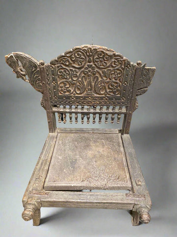 Asymmetrical Indian wooden prayer stool featuring a horse head, hand carved with stunning intricacy.