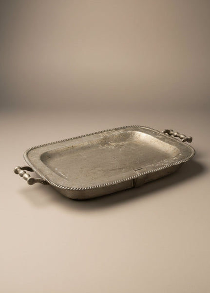 Pewter meat warming serving tray with a decorative ridged edge.
