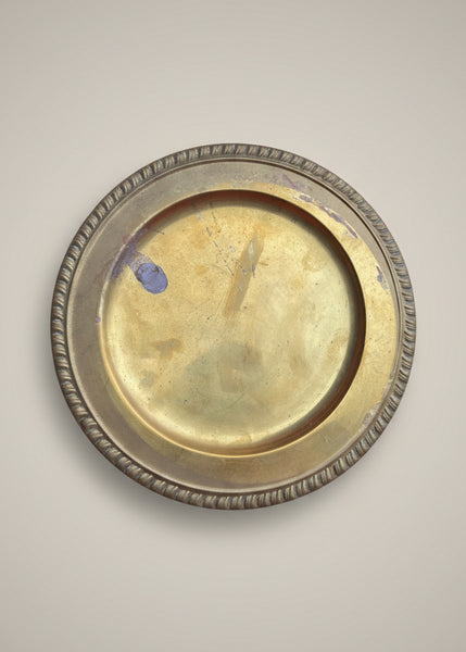 A large gold charger plate with a ribbed edge.