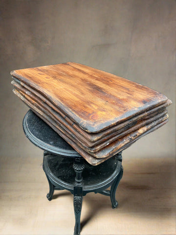 A set of large antique rustic wooden breadboards.