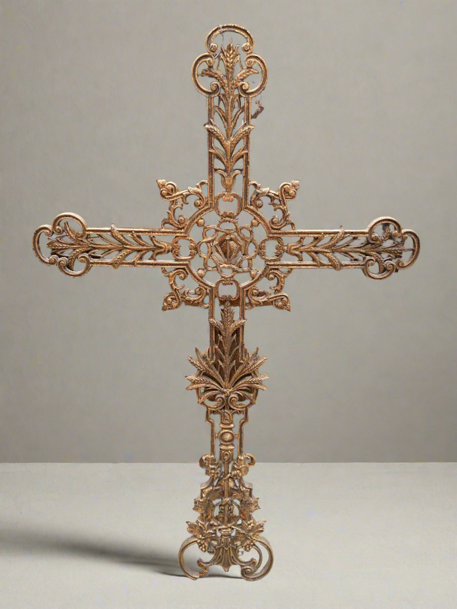 Solid cast metal altar cross in a gold finish. Beautiful ornate details featuring bunches of grapes and sheaves of corn.