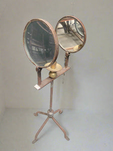 Large candlelit magnifying mirror, in an aged condition. Could also be classed as a parabolic wick lamp (a magnifying apparatus.)