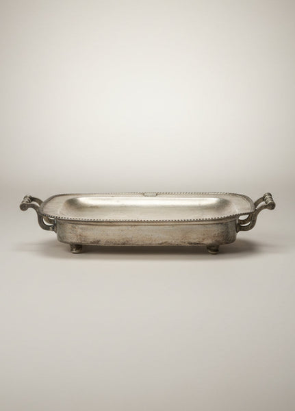 Pewter meat warming serving tray with a decorative ridged edge.