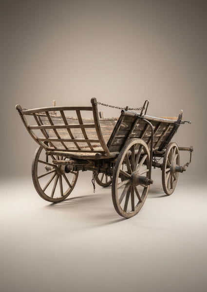 Antique wooden hand cart with a curved, gridded back, suspended by a chain.