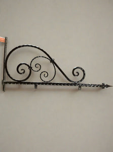 Decorative wrought iron sign bracket, with an arrowhead peak.