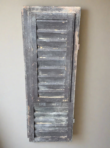 Large brown painted window shutter, in an aged condition.