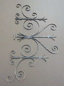 Large ornate symmetrical wrought iron bracket, with some light aging.