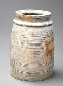 Large carved wooden vase with a decorative ridged finish.