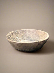 Small hand-carved wooden bowl in an aged condition.