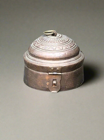 Copper-lidded decorative storage pot with a hammered body and patterned lid.