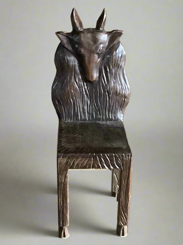 Unique European style hand-carved wooden chair in the shape of a goat head.