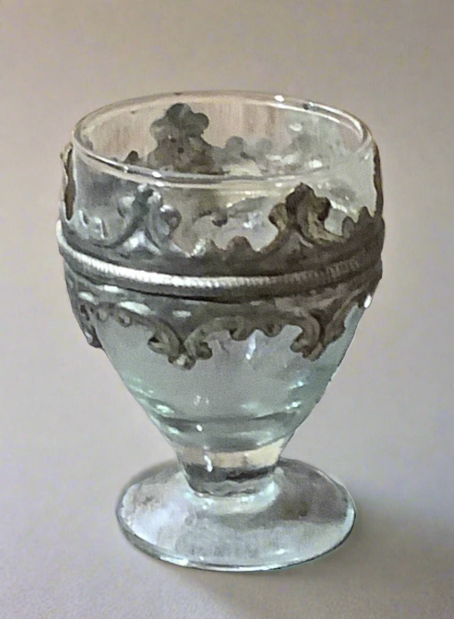 A set of medieval-style glass and pewter wine goblets with short stems.