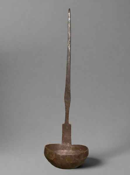 Large metal ladle with a hammered effect bowl.