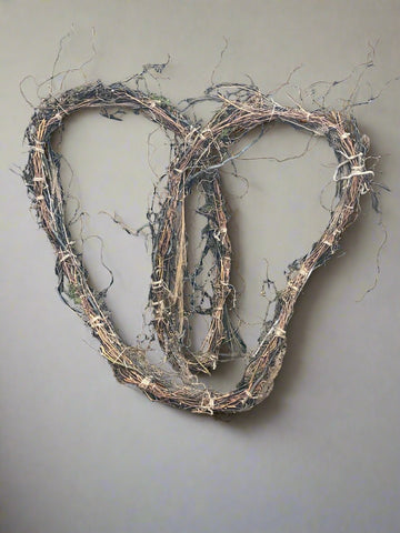 Garland made from woodland materials, crafted in the shape of a heart.