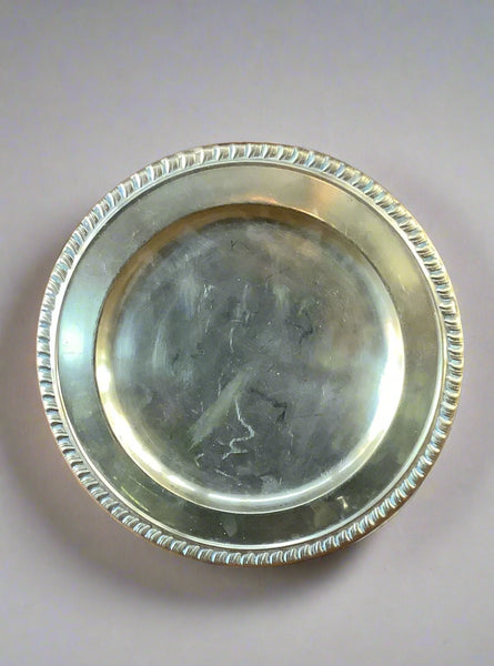 A large gold charger plate with a ribbed edge.