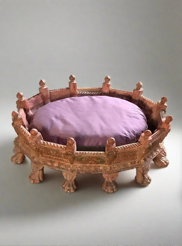 Ornate carved wooden dog bed with 'dog-like' feet and pointed finials.