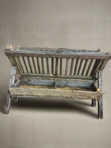 Wooden angled hay manger in an aged condition.