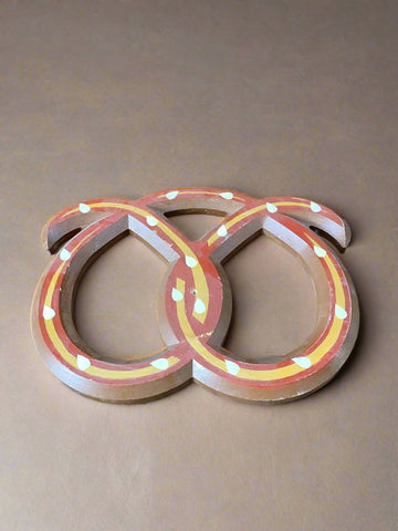 German-style decorative wooden pretzel wall art, in a hand-painted colourful style.