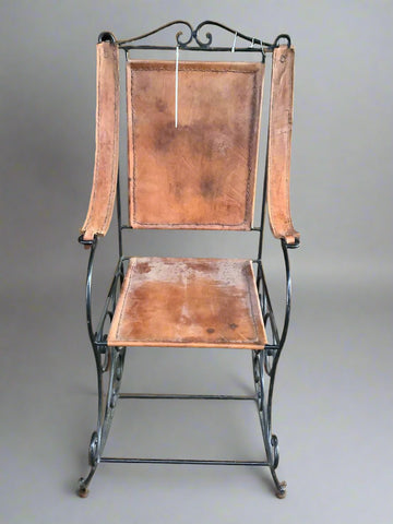 Vintage leather rocking chair with 'sling style' leather arms and wrought iron frame.