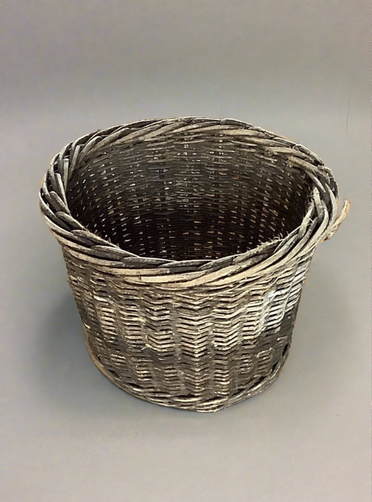 Small round wicker bin in an aged condition.