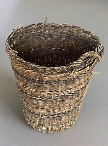 Tall round wicker basket, ideal for storing logs.