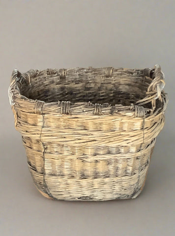 Tall oblong wicker basket, ideal for storing logs. In an aged condition.