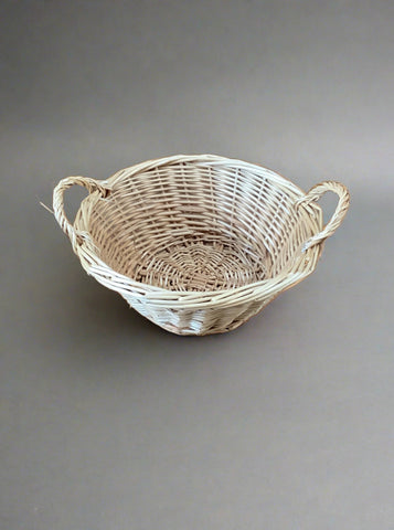 Small round wicker fruit basket with double handles.