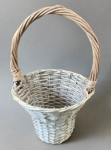 Grey wicker bouquet basket, woven into a fluted shape with a thick carrying handle.