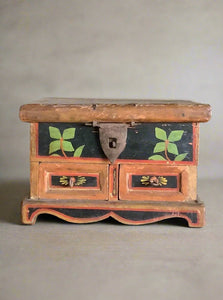 Small Scandinavian-style wooden jewellery box with painted floral details.