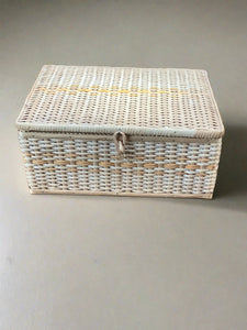 Wicker sewing hamper with an orange fabric interior.