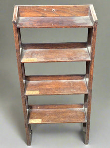 Wooden four-shelf unit with an inlaid light-coloured wood design.