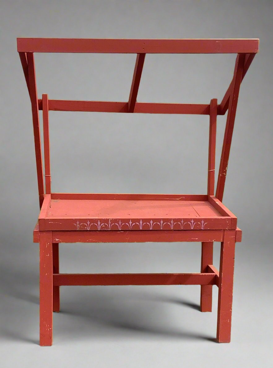 Red wooden painted market stall with an awning and stenciled pattern to the front.