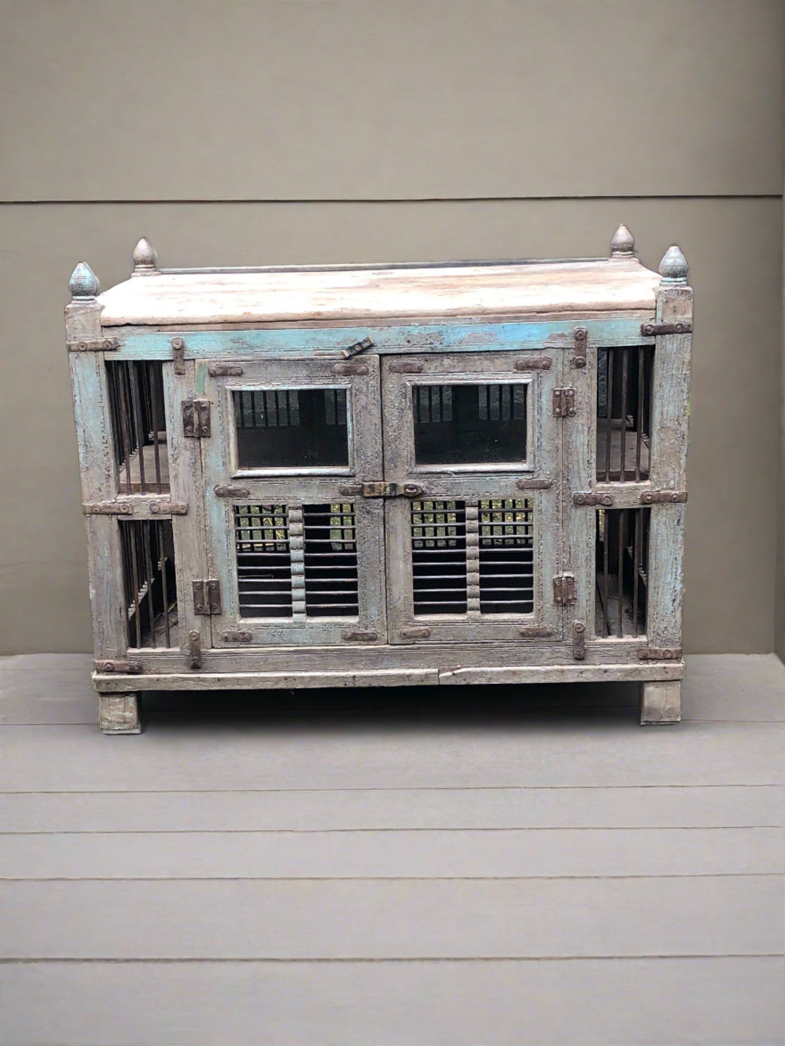 Large wooden bird cage with double doors and two tiers. Decorated with round wooden finials.