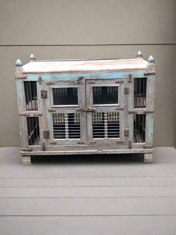 Large wooden bird cage with double doors and two tiers. Decorated with round wooden finials.