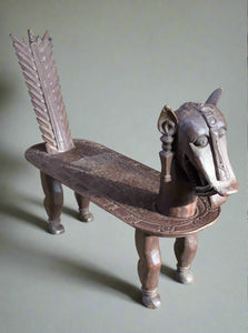 Asian style carved wooden&nbsp;seat in the shape of a dragon or other mythical creature. Possibly Egyptian, from the early 1900s when Howard Carter found the tomb of King&nbsp;Tutankhamun. The design could also be inspired by Chinese dragons.&nbsp;  The wood looks like Huang Li which is a dense Asian relative of walnut.