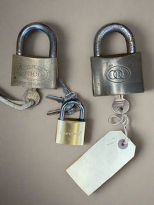 Trio of metal padlocks.