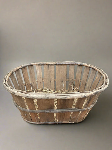 Rustic wooden slatted baskets lined with hay.