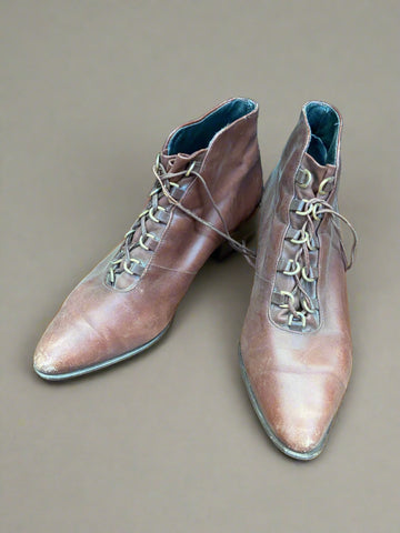 A pair of lace-up brown leather Victorian boots.