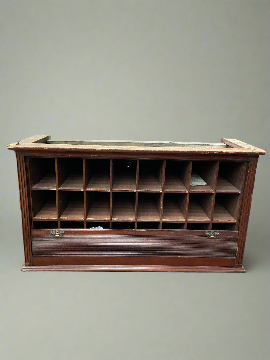 24 docket wooden storage unit, typically seen in hotels to store room keys, documents, etc. The front panel can be pulled up to store the items out of view.