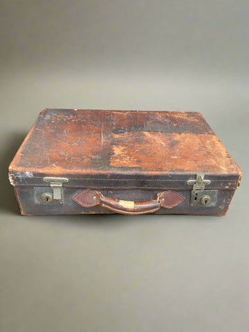 Brown stitched leather suitcase in a heavily aged condition.