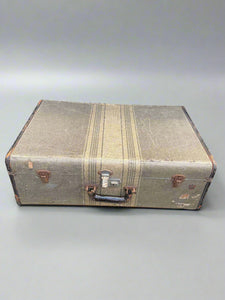 1940s style cream and grey striped suitcase with a shiny black handle.